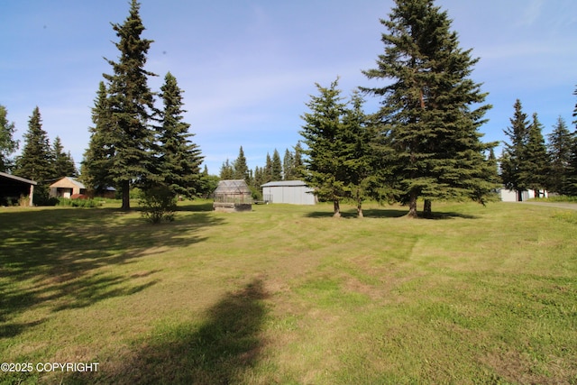 63550 Jessica G Ct, Ninilchik, AK 99639 - view of green lawn with a greenhouse and an outdoor structure