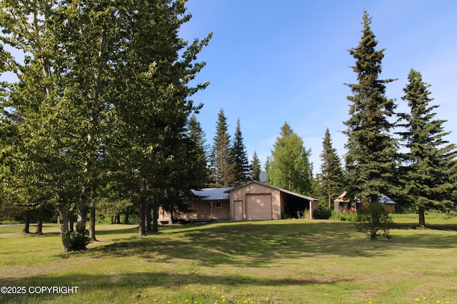 63550 Jessica G Ct, Ninilchik, AK 99639 - view of green lawn featuring a detached garage and an outdoor structure