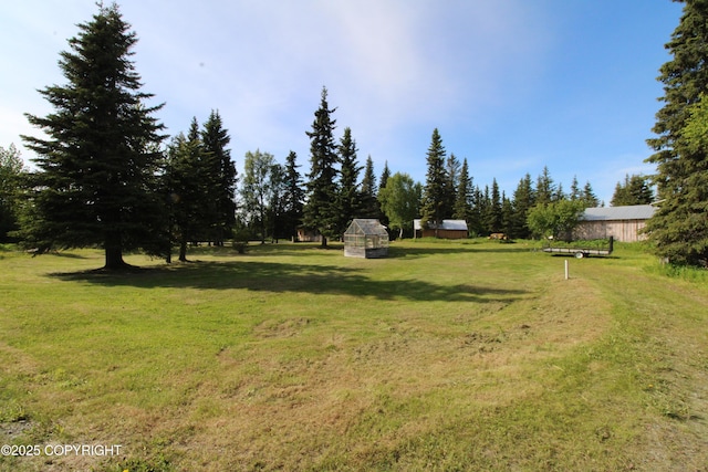 63550 Jessica G Ct, Ninilchik, AK 99639 - view of grassy yard with an outbuilding and a greenhouse