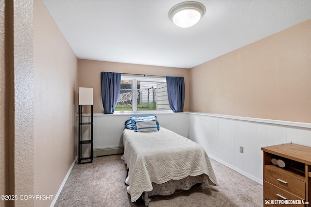811 Bounty Dr, Anchorage, AK 99515 - carpeted bedroom featuring a baseboard radiator and a wainscoted wall