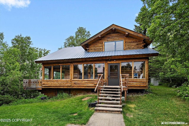 7550 E Fireweed Rd, Palmer, AK 99645 - log cabin featuring a sunroom, a front yard, metal roof, a wooden deck, and log siding