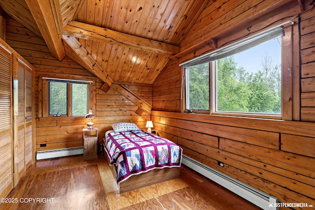 7550 E Fireweed Rd, Palmer, AK 99645 - bedroom featuring baseboard heating, wooden walls, and wood finished floors