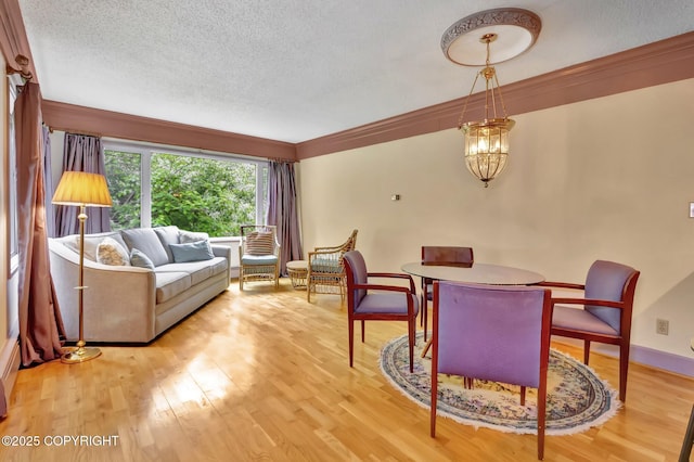 836 O Pl, Anchorage, AK 99501 - dining room with a textured ceiling, light wood-style floors, crown molding, and baseboards