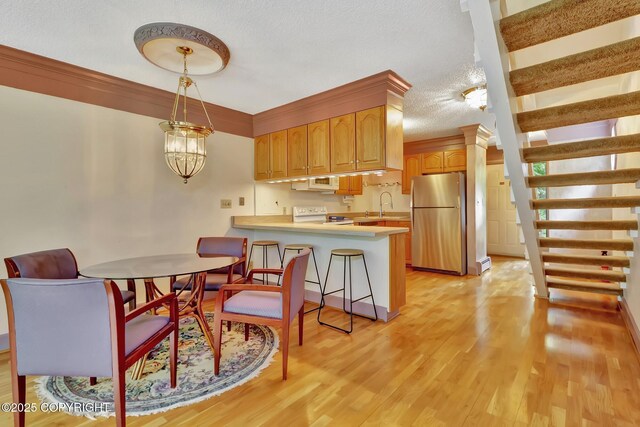 836 O Pl, Anchorage, AK 99501 - dining room featuring light wood finished floors and a textured ceiling