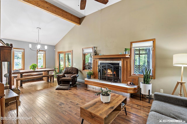 2020 N Kentucky Derby Dr, Palmer, AK 99645 - living room featuring high vaulted ceiling, beam ceiling, a ceiling fan, hardwood / wood-style floors, and a warm lit fireplace