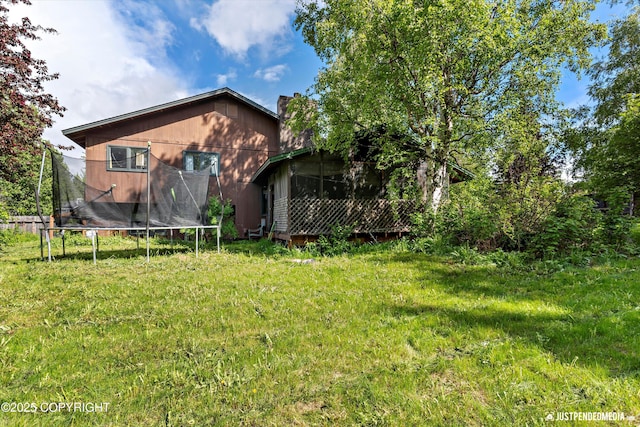 2020 N Kentucky Derby Dr, Palmer, AK 99645 - rear view of property with a trampoline and a yard