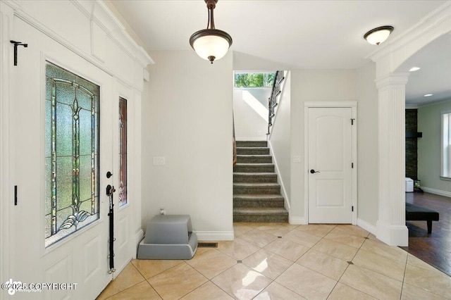 4920 W Fairview Loop, Wasilla, AK 99654 - foyer featuring decorative columns, stairway, light tile patterned floors, and arched walkways