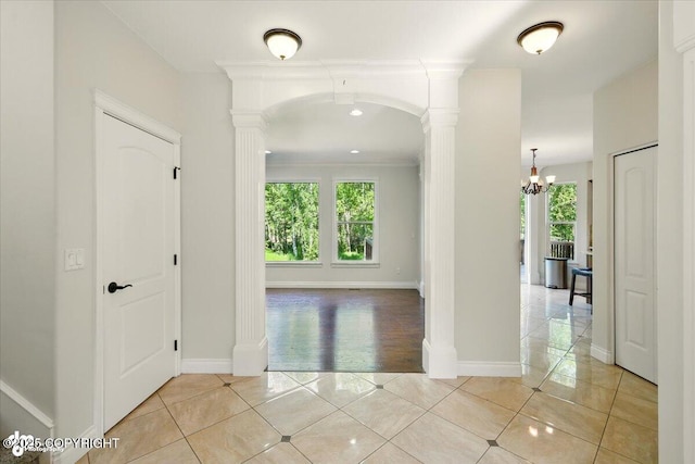 4920 W Fairview Loop, Wasilla, AK 99654 - corridor with decorative columns, light tile patterned floors, and healthy amount of natural light