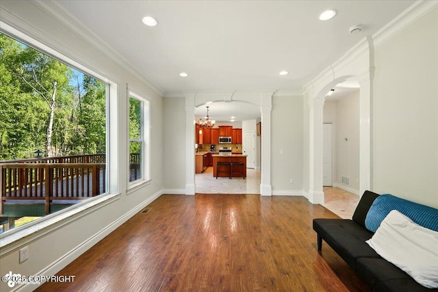 4920 W Fairview Loop, Wasilla, AK 99654 - sitting room with crown molding, a chandelier, wood finished floors, ornate columns, and recessed lighting