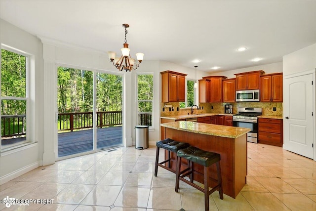 4920 W Fairview Loop, Wasilla, AK 99654 - kitchen featuring stainless steel appliances, a chandelier, backsplash, pendant lighting, and recessed lighting