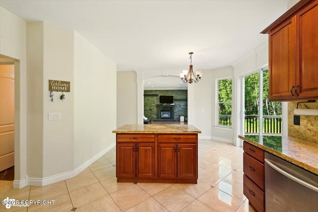 4920 W Fairview Loop, Wasilla, AK 99654 - kitchen featuring stainless steel dishwasher, light tile patterned floors, a chandelier, and a fireplace