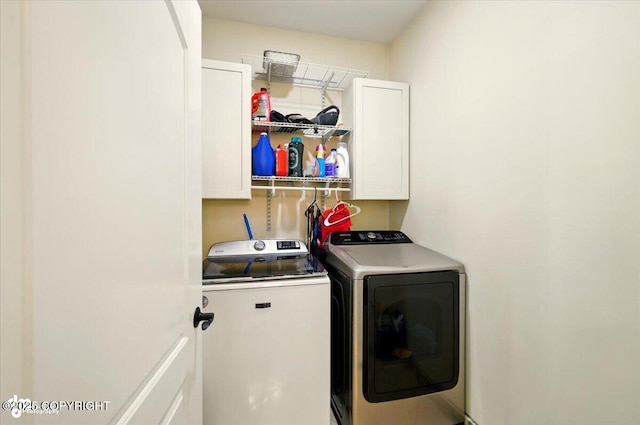 4920 W Fairview Loop, Wasilla, AK 99654 - washroom with cabinet space and washing machine and clothes dryer