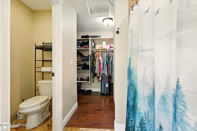 4920 W Fairview Loop, Wasilla, AK 99654 - full bathroom featuring wood finished floors, a spacious closet, and curtained shower