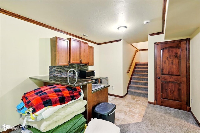 4920 W Fairview Loop, Wasilla, AK 99654 - kitchen featuring stainless steel microwave, dark countertops, a peninsula, decorative backsplash, and a kitchen breakfast bar