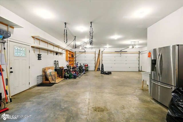 4920 W Fairview Loop, Wasilla, AK 99654 - garage featuring stainless steel refrigerator with ice dispenser and a garage door opener