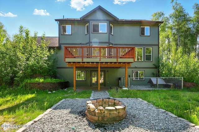 4920 W Fairview Loop, Wasilla, AK 99654 - back of house featuring an outdoor fire pit, a wooden deck, french doors, and a patio