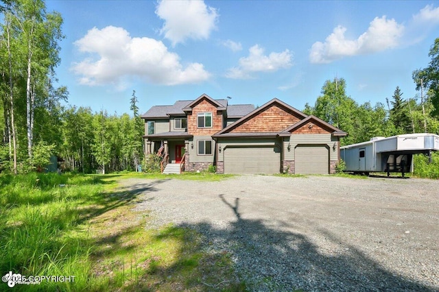 4920 W Fairview Loop, Wasilla, AK 99654 - view of front of property with stone siding, an attached garage, and driveway