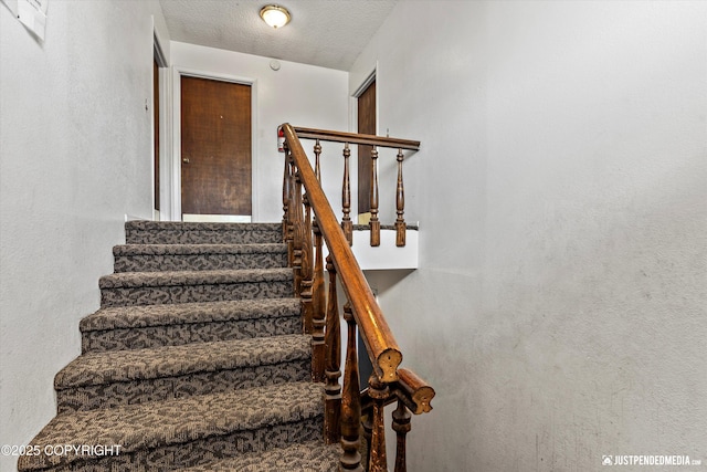 4417 San Roberto Ave, Anchorage, AK 99508 - stairway featuring a textured ceiling