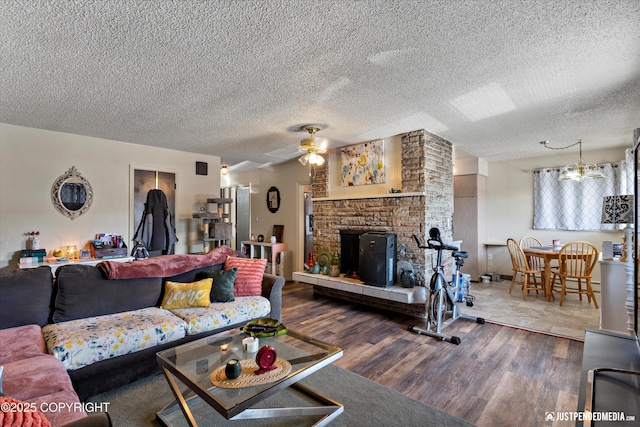 4417 San Roberto Ave, Anchorage, AK 99508 - living room featuring wood finished floors, a ceiling fan, a textured ceiling, and a large fireplace