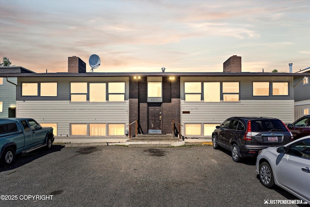 4417 San Roberto Ave, Anchorage, AK 99508 - view of front of home with a chimney and brick siding