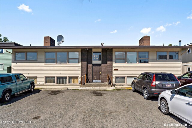 4417 San Roberto Ave, Anchorage, AK 99508 - townhome / multi-family property with a chimney and brick siding