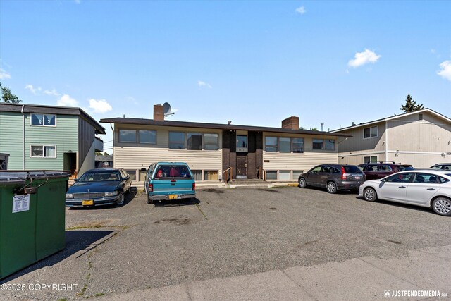 4417 San Roberto Ave, Anchorage, AK 99508 - view of front facade featuring uncovered parking and a chimney