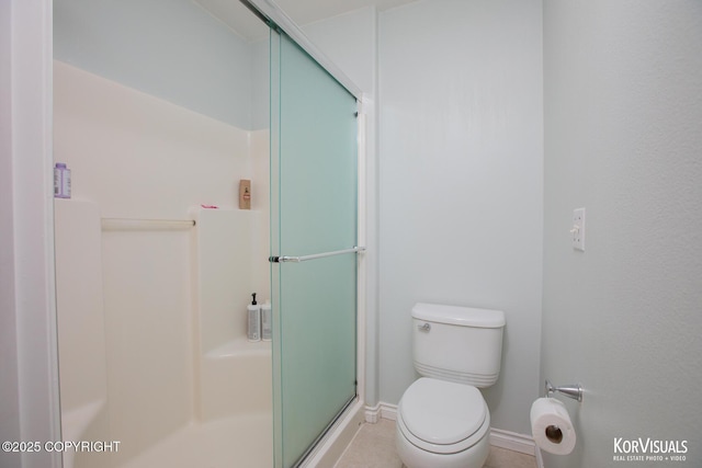 2690 E Tamarak Ave, Wasilla, AK 99654 - bathroom with baseboards, a shower stall, and toilet