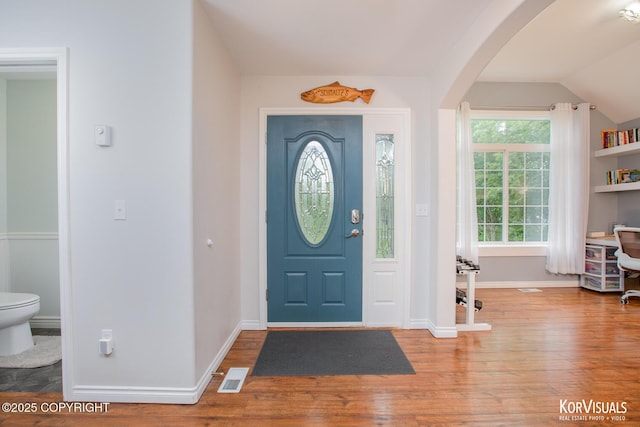 2690 E Tamarak Ave, Wasilla, AK 99654 - foyer entrance featuring arched walkways, wood finished floors, lofted ceiling, and baseboards