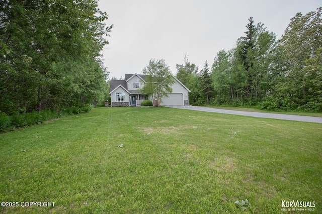 2690 E Tamarak Ave, Wasilla, AK 99654 - view of front of property with driveway, an attached garage, and a front lawn
