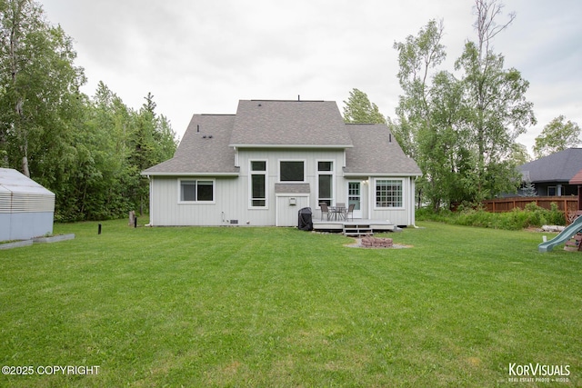 2690 E Tamarak Ave, Wasilla, AK 99654 - back of property featuring a deck, roof with shingles, and a lawn