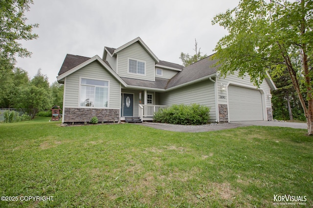 2690 E Tamarak Ave, Wasilla, AK 99654 - view of front facade with stone siding, an attached garage, asphalt driveway, and a front lawn