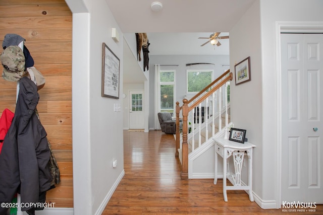 2690 E Tamarak Ave, Wasilla, AK 99654 - hallway featuring wood finished floors, baseboards, stairway, and arched walkways