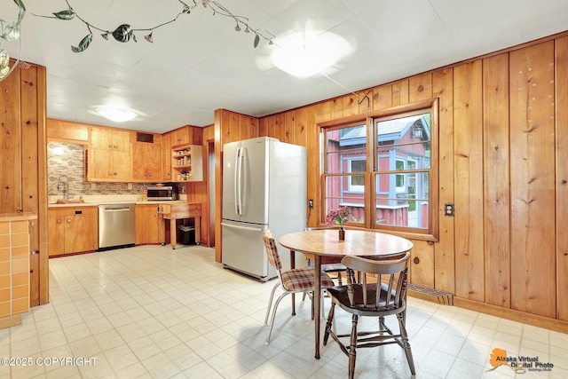 3200 E 15th Ave, Anchorage, AK 99508 - dining area with wood walls and light floors
