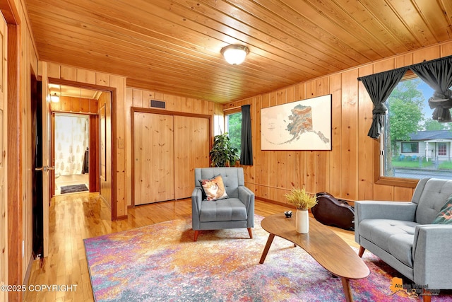 3200 E 15th Ave, Anchorage, AK 99508 - sitting room featuring wood walls, plenty of natural light, wooden ceiling, and light wood finished floors