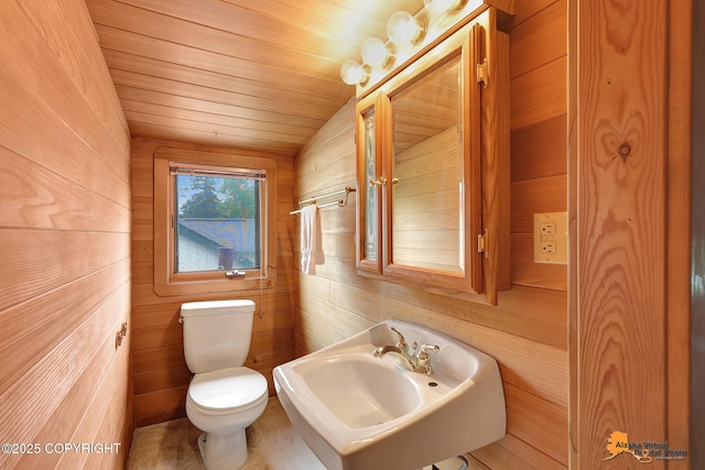 3200 E 15th Ave, Anchorage, AK 99508 - bathroom with toilet, a sink, wood walls, and wooden ceiling
