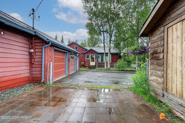 3200 E 15th Ave, Anchorage, AK 99508 - view of patio / terrace with a garage, driveway, and an outdoor structure