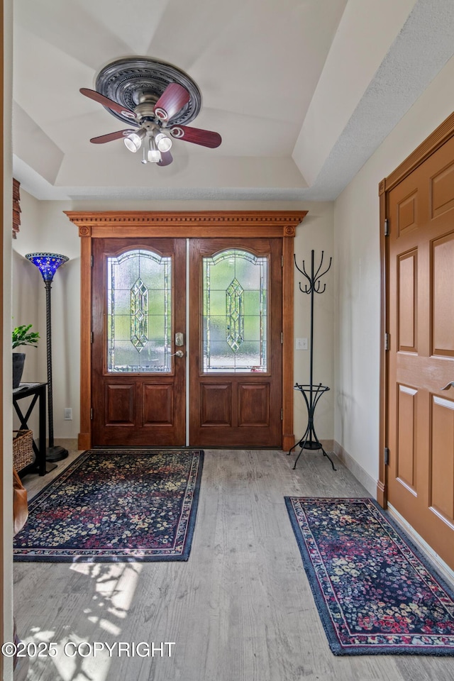 38686 Hart Ct, Soldotna, AK 99669 - foyer with light wood-style floors, ceiling fan, and a tray ceiling