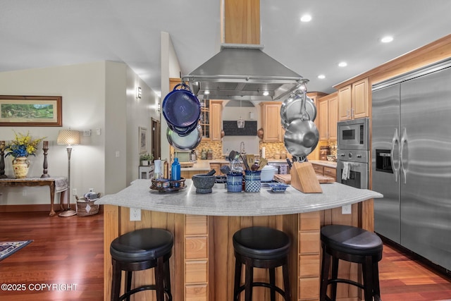 38686 Hart Ct, Soldotna, AK 99669 - kitchen featuring built in appliances, dark wood-style flooring, light brown cabinetry, backsplash, and island range hood