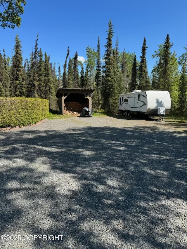 38686 Hart Ct, Soldotna, AK 99669 - view of dirt / gravel road with a forest view