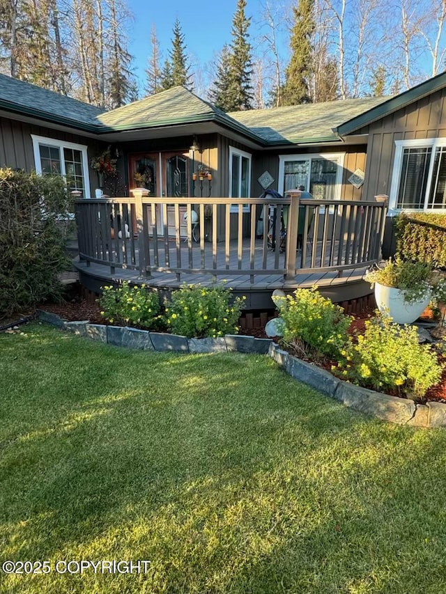 38686 Hart Ct, Soldotna, AK 99669 - back of property with board and batten siding, a deck, and a yard