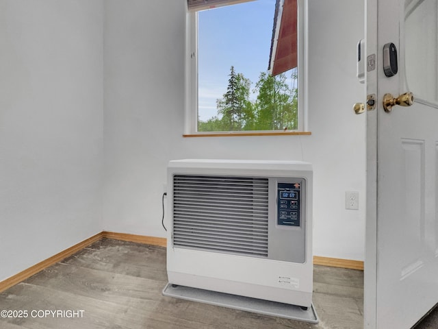 26839 S Talkeetna Spur Rd, Talkeetna, AK 99676 - detailed view of heating unit, baseboards, and wood finished floors