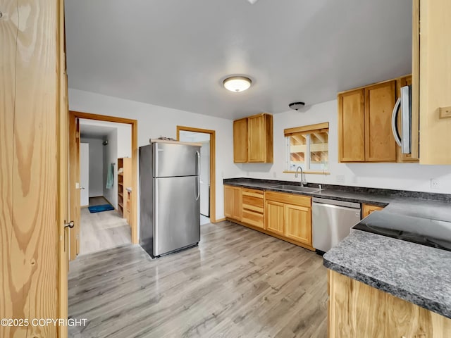 26839 S Talkeetna Spur Rd, Talkeetna, AK 99676 - kitchen featuring stainless steel appliances, a sink, light wood-style floors, and dark countertops