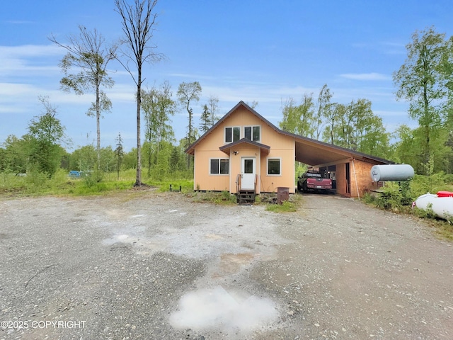26839 S Talkeetna Spur Rd, Talkeetna, AK 99676 - view of home's exterior featuring an attached carport, driveway, and entry steps