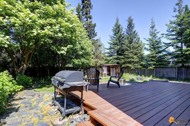 3941 Eric Cir, Anchorage, AK 99507 - wooden terrace with a fenced backyard and a grill
