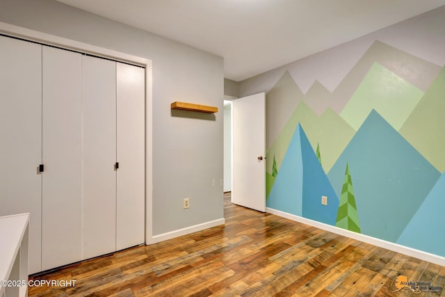 3941 Eric Cir, Anchorage, AK 99507 - unfurnished bedroom featuring hardwood / wood-style floors and a closet
