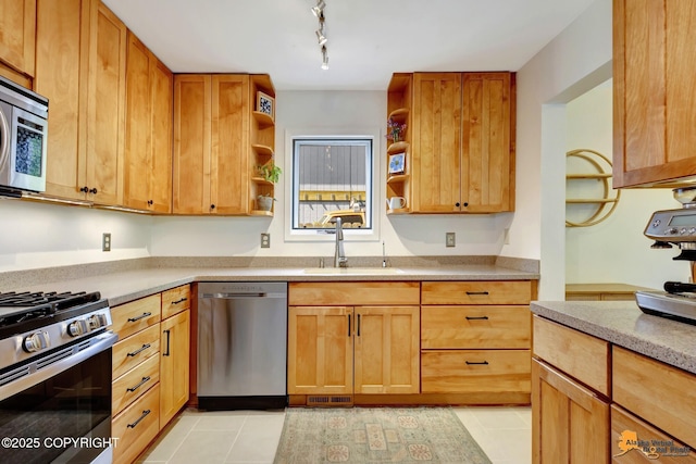 3941 Eric Cir, Anchorage, AK 99507 - kitchen with stainless steel appliances, open shelves, light tile patterned flooring, light countertops, and rail lighting