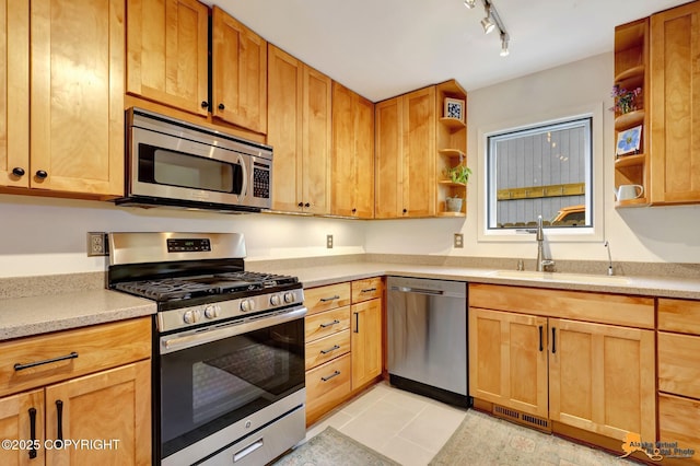 3941 Eric Cir, Anchorage, AK 99507 - kitchen featuring appliances with stainless steel finishes, open shelves, light countertops, track lighting, and light tile patterned flooring