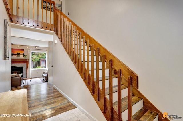 3941 Eric Cir, Anchorage, AK 99507 - staircase featuring a lit fireplace and wood finished floors