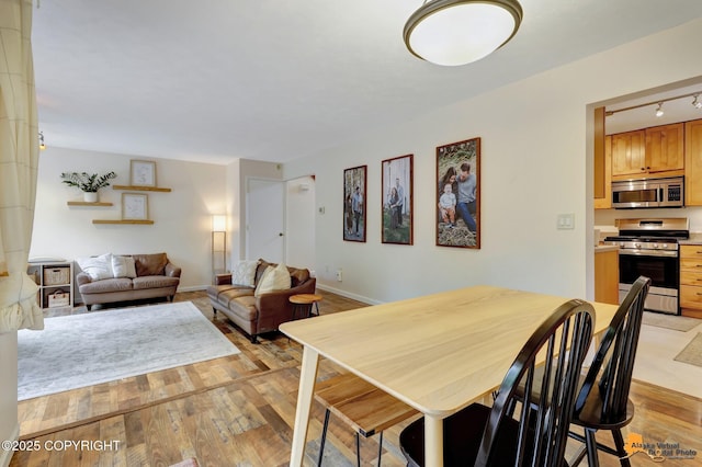 3941 Eric Cir, Anchorage, AK 99507 - dining room with light wood-style floors and rail lighting