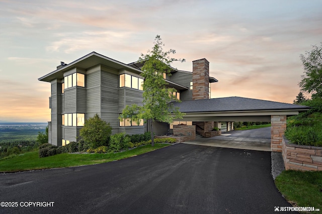 9900 Hillhaven Cir, Anchorage, AK 99507 - contemporary house featuring a chimney and driveway